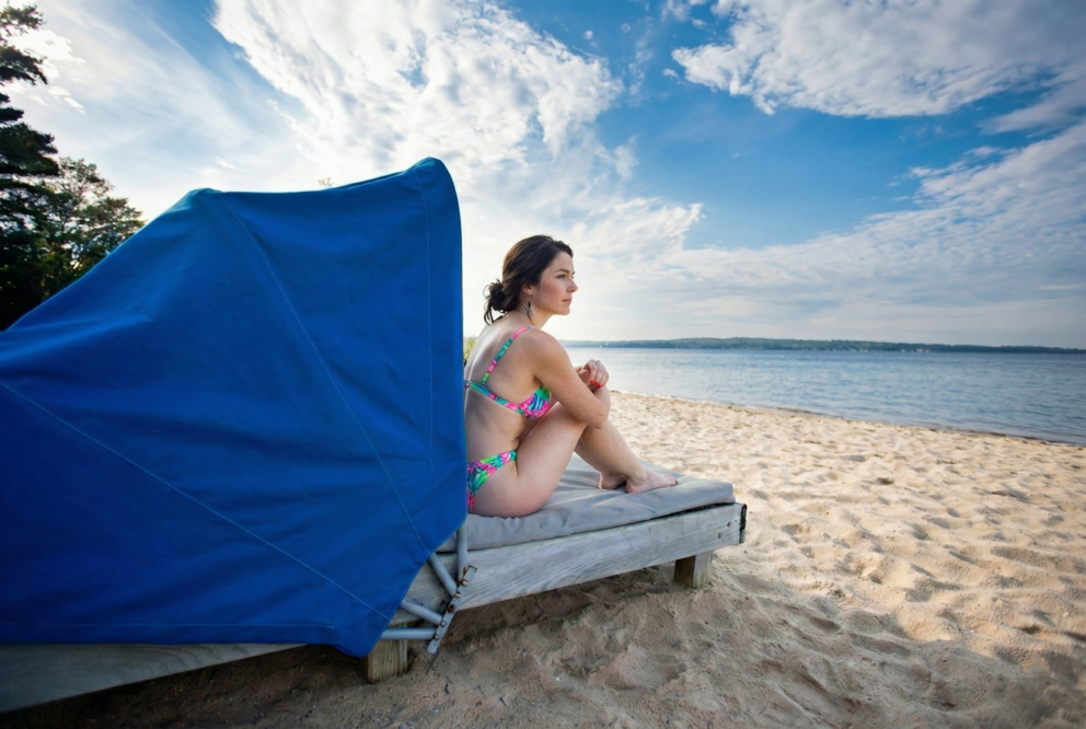 a woman sitting on a beach chair